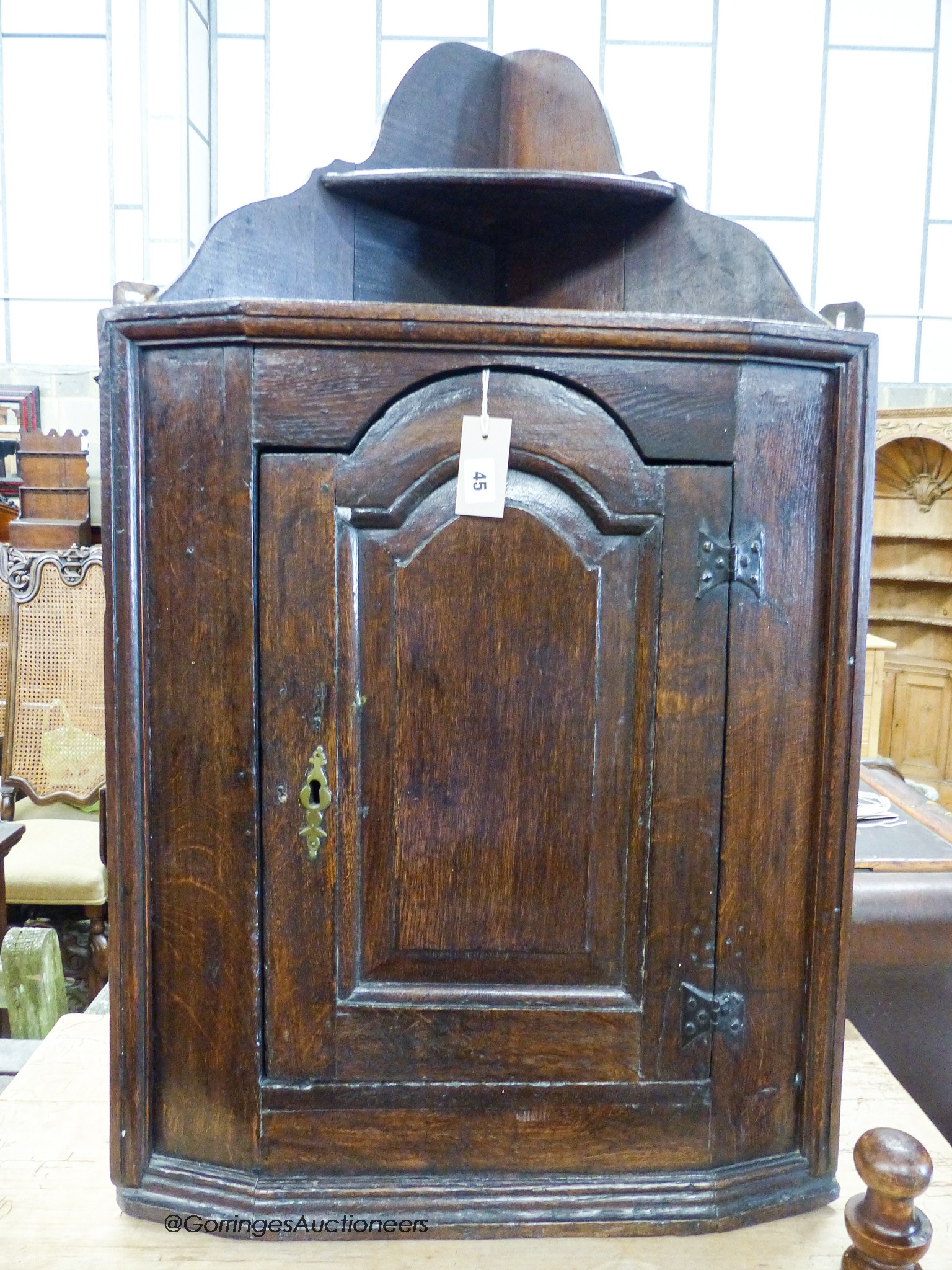 A late 17th century oak hanging corner cupboard